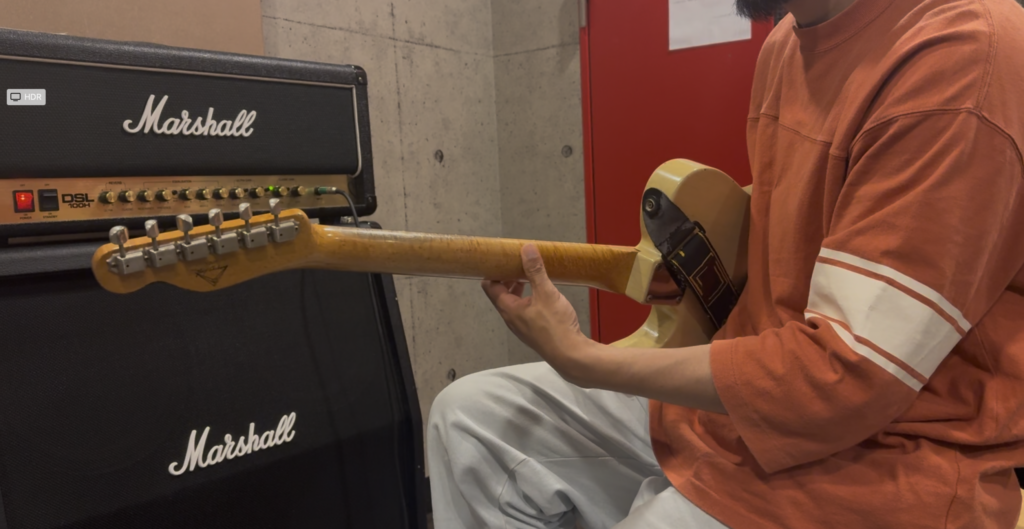 千歳烏山ギター教室の講師がスライドについて解説するレッスンの様子。