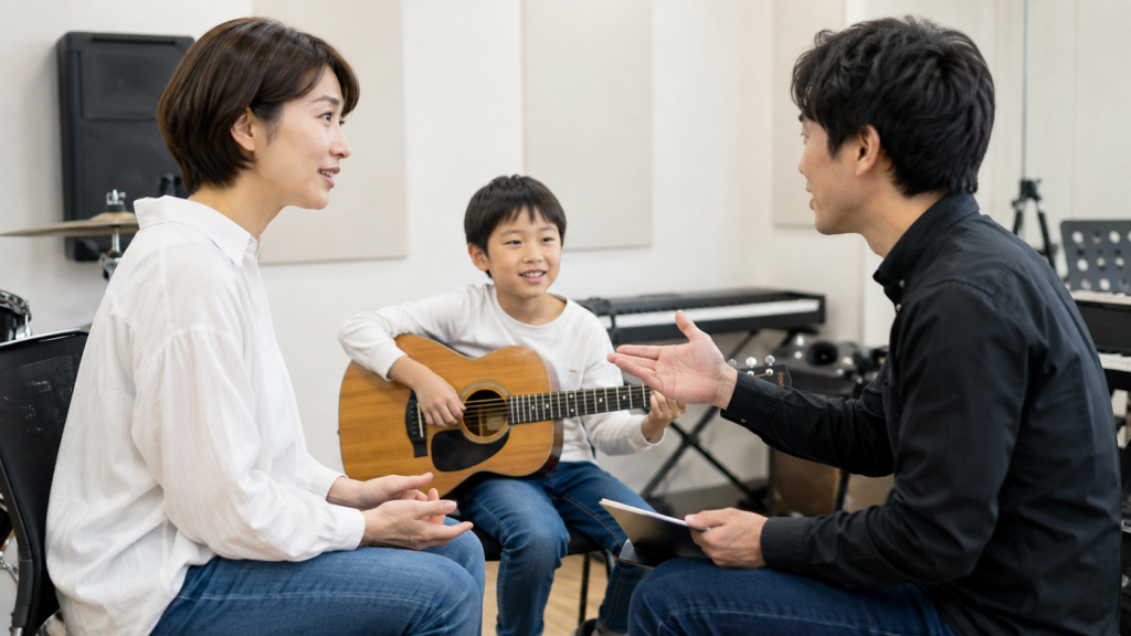 子どものギターレッスンについて講師へ相談する保護者